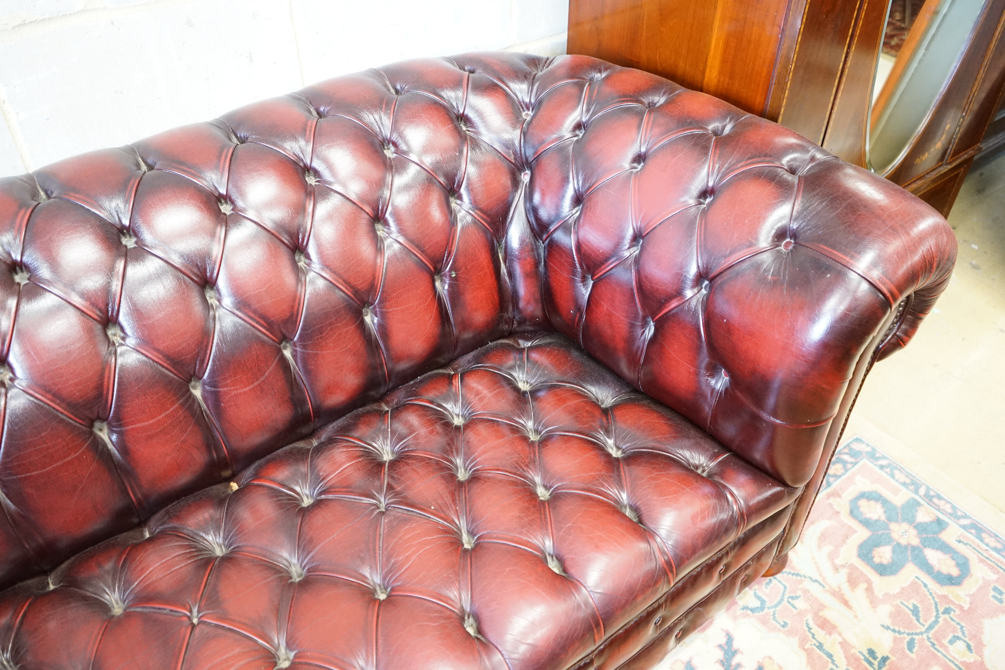 A Victorian style buttoned burgundy leather Chesterfield settee, length 200cm, width 90cm, height 74cm